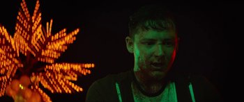 Movie still from “The Strangers: Prey at Night” (2018), directed by Johannes Roberts – A man with a beard and red lipstick on his face; Close Up shot, Low angle