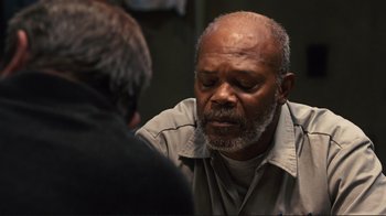 Movie still from “The Sunset Limited” (2011), directed by Tommy Lee Jones – An older man is talking to a younger man; Close Up shot, Over the shoulder angle