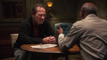Movie still from “The Sunset Limited” (2011), directed by Tommy Lee Jones – Two men sitting at a table talking to each other; Medium shot, Over the shoulder angle