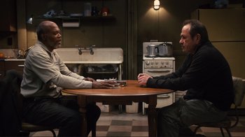 Movie still from “The Sunset Limited” (2011), directed by Tommy Lee Jones – Two men sitting at a table in front of each other; Medium shot, High angle