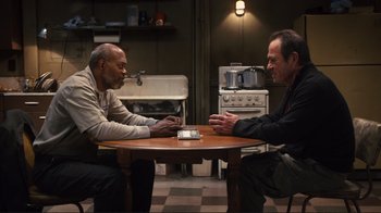 Movie still from “The Sunset Limited” (2011), directed by Tommy Lee Jones – Two men sitting at a table in front of each other; Medium shot, High angle