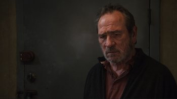 Movie still from “The Sunset Limited” (2011), directed by Tommy Lee Jones – An older man with a beard is looking at the camera; Close Up shot, Low angle