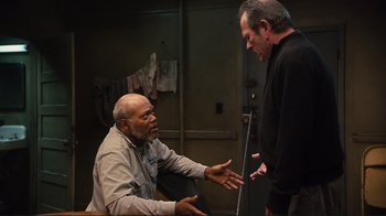 Movie still from “The Sunset Limited” (2011), directed by Tommy Lee Jones – Two men talking to each other in a room; Medium shot, Over the shoulder angle