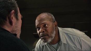 Movie still from “The Sunset Limited” (2011), directed by Tommy Lee Jones – An older man with a gray beard is looking at a younger man; Close Up shot, Low angle