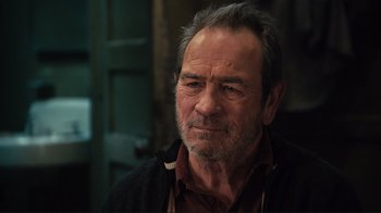 Movie still from “The Sunset Limited” (2011), directed by Tommy Lee Jones – An older man with grey hair and a beard; Close Up shot, Over the shoulder angle
