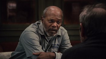 Movie still from “The Sunset Limited” (2011), directed by Tommy Lee Jones – An older man sitting in front of another older man; Close Up shot, Over the shoulder angle