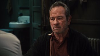 Movie still from “The Sunset Limited” (2011), directed by Tommy Lee Jones – An older man sitting in front of a mirror; Close Up shot, Over the shoulder angle