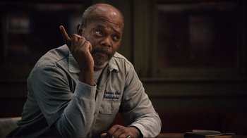 Movie still from “The Sunset Limited” (2011), directed by Tommy Lee Jones – An older man sitting at a table in front of a window; Close Up shot, Over the shoulder angle