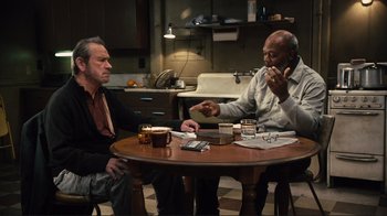 Movie still from “The Sunset Limited” (2011), directed by Tommy Lee Jones – Two men sitting at a table in a kitchen; Medium shot, High angle