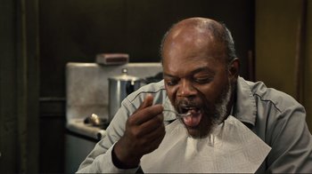 Movie still from “The Sunset Limited” (2011), directed by Tommy Lee Jones – An older man brushing his teeth with a tooth brush; Close Up shot, High angle