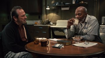Movie still from “The Sunset Limited” (2011), directed by Tommy Lee Jones – Two men are sitting at a table eating food; Medium shot, Over the shoulder angle