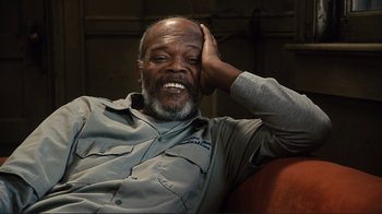 Movie still from “The Sunset Limited” (2011), directed by Tommy Lee Jones – An older man sitting on a couch with his hand on his head; Close Up shot, Low angle