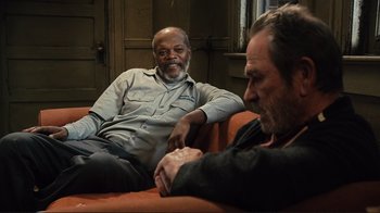 Movie still from “The Sunset Limited” (2011), directed by Tommy Lee Jones – Two men are sitting on a couch and talking; Medium shot, High angle