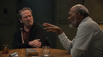 Movie still from “The Sunset Limited” (2011), directed by Tommy Lee Jones – Two men sitting at a table talking to each other; Medium shot, Over the shoulder angle