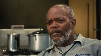 Movie still from “The Sunset Limited” (2011), directed by Tommy Lee Jones – An older man is sitting in front of a stove; Close Up shot, Low angle