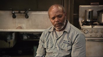 Movie still from “The Sunset Limited” (2011), directed by Tommy Lee Jones – An older man sitting in front of a sink; Close Up shot, High angle