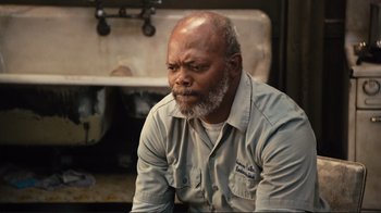 Movie still from “The Sunset Limited” (2011), directed by Tommy Lee Jones – An older man sitting in front of an old sink; Close Up shot, High angle