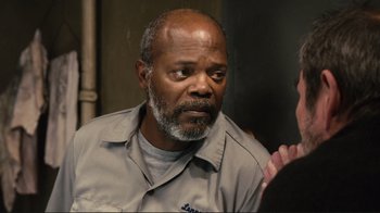 Movie still from “The Sunset Limited” (2011), directed by Tommy Lee Jones – An older man with a gray beard is talking to someone; Close Up shot, Over the shoulder angle