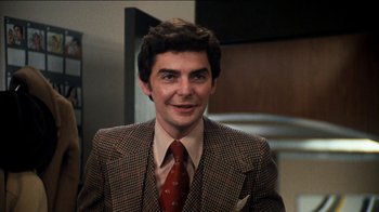 Movie still from “The Sunshine Boys” (1975), directed by Herbert Ross – A man in a suit and tie smiling for the camera; Close Up shot, Low angle