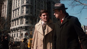 Movie still from “The Sunshine Boys” (1975), directed by Herbert Ross – Two men are walking down the street together; Medium shot, Over the shoulder angle