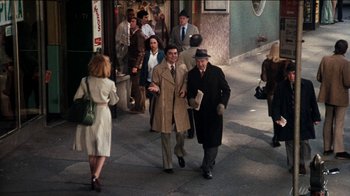 Movie still from “The Sunshine Boys” (1975), directed by Herbert Ross – A man and a woman walking down a street; Wide shot, Over the shoulder angle