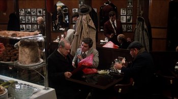 Movie still from “The Sunshine Boys” (1975), directed by Herbert Ross – A group of men sitting at a table in a restaurant; Wide shot, Over the shoulder angle