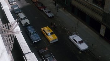 Movie still from “The Sunshine Boys” (1975), directed by Herbert Ross – An overhead view of a street with a taxi cab and other cars; Extreme Wide shot, High angle