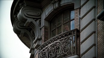 Movie still from “The Sunshine Boys” (1975), directed by Herbert Ross – A building with a wrought iron railing on it's balcony; Wide shot, Low angle