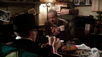 Movie still from “The Sunshine Boys” (1975), directed by Herbert Ross – Two men sitting at a table with a cup of coffee; Medium shot, Over the shoulder angle