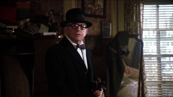 Movie still from “The Sunshine Boys” (1975), directed by Herbert Ross – An older man wearing a suit and bow tie; Medium shot, Over the shoulder angle