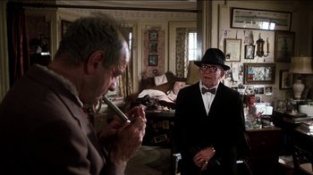 Movie still from “The Sunshine Boys” (1975), directed by Herbert Ross – Two older men in suits and ties in a room; Medium shot, Over the shoulder angle