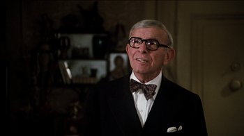 Movie still from “The Sunshine Boys” (1975), directed by Herbert Ross – An older man wearing a suit and bow tie; Close Up shot, Over the shoulder angle