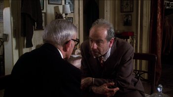 Movie still from “The Sunshine Boys” (1975), directed by Herbert Ross – Two older men are sitting in a room talking to each other; Medium shot, Over the shoulder angle