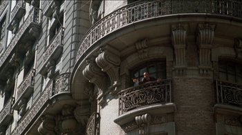 Movie still from “The Sunshine Boys” (1975), directed by Herbert Ross – Two people standing on a balcony of a building; Extreme Wide shot, Low angle