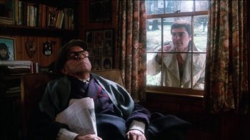 Movie still from “The Sunshine Boys” (1975), directed by Herbert Ross – An old man sitting in a chair looking out a window at another man; Medium shot, Over the shoulder angle