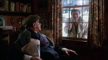 Movie still from “The Sunshine Boys” (1975), directed by Herbert Ross – An older man sitting in front of a window looking at a young woman; Medium shot, Over the shoulder angle