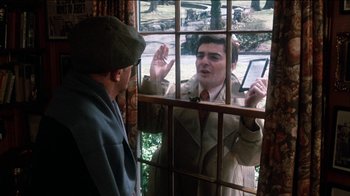 Movie still from “The Sunshine Boys” (1975), directed by Herbert Ross – A man is talking to a man through a window; Medium shot, Over the shoulder angle
