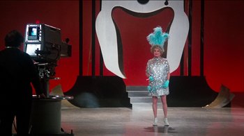 Movie still from “The Sunshine Boys” (1975), directed by Herbert Ross – A woman in a silver dress on a stage; Wide shot, Low angle