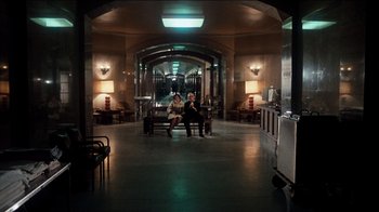 Movie still from “The Sunshine Boys” (1975), directed by Herbert Ross – Two people sitting on a bench in a building; Extreme Wide shot, High angle