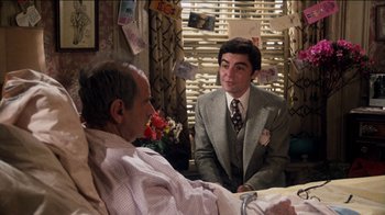 Movie still from “The Sunshine Boys” (1975), directed by Herbert Ross – A man in a suit sitting next to another man in a suit; Medium shot, Over the shoulder angle