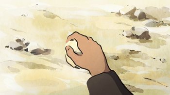 Movie still from “The Swallows of Kabul” (2019), directed by Zabou Breitman – A hand is holding a computer mouse in the sand; Extreme Close Up shot, Overhead angle