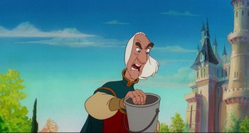 Movie still from “The Swan Princess” (1994), directed by Richard Rich – A man with a white beard holding a bucket; Medium shot, Over the shoulder angle