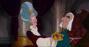 Movie still from “The Swan Princess” (1994), directed by Richard Rich – A woman holding a cake in front of an older man; Medium shot, Over the shoulder angle
