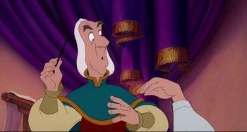 Movie still from “The Swan Princess” (1994), directed by Richard Rich – A cartoon of a man with a wand in his hand; Medium shot, Over the shoulder angle