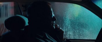 Movie still from “The Sweet Hereafter” (1997), directed by Atom Egoyan – A man sitting in the back seat of a car looking out the window; Close Up shot, Over the shoulder angle