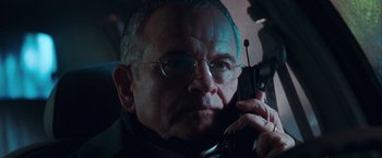 Movie still from “The Sweet Hereafter” (1997), directed by Atom Egoyan – An older man talking on a cell phone while wearing glasses; Close Up shot, Low angle