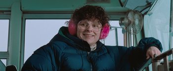 Movie still from “The Sweet Hereafter” (1997), directed by Atom Egoyan – A woman wearing ear muffs and a blue jacket; Close Up shot, Low angle