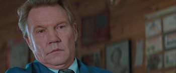 Movie still from “The Sweet Hereafter” (1997), directed by Atom Egoyan – An older man wearing a blue jacket and a green tie; Close Up shot, Over the shoulder angle