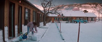 Movie still from “The Sweet Hereafter” (1997), directed by Atom Egoyan – A woman is standing in the snow near a tree; Extreme Wide shot, High angle