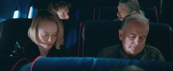 Movie still from “The Sweet Hereafter” (1997), directed by Atom Egoyan – A group of people sitting on a bus; Close Up shot, Over the shoulder angle